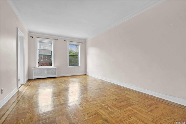 unfurnished room featuring radiator heating unit, light parquet floors, and ornamental molding