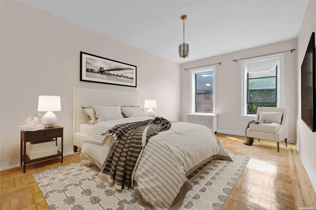 bedroom with light parquet floors