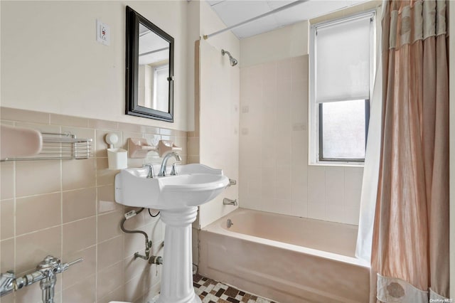 bathroom featuring shower / tub combo and tile walls