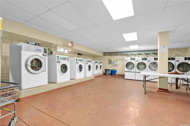 clothes washing area with washing machine and dryer