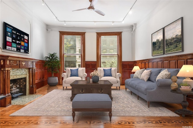 living room featuring ceiling fan, light hardwood / wood-style flooring, track lighting, and ornamental molding