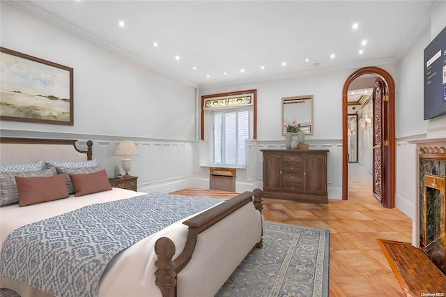 bedroom with crown molding and light parquet flooring