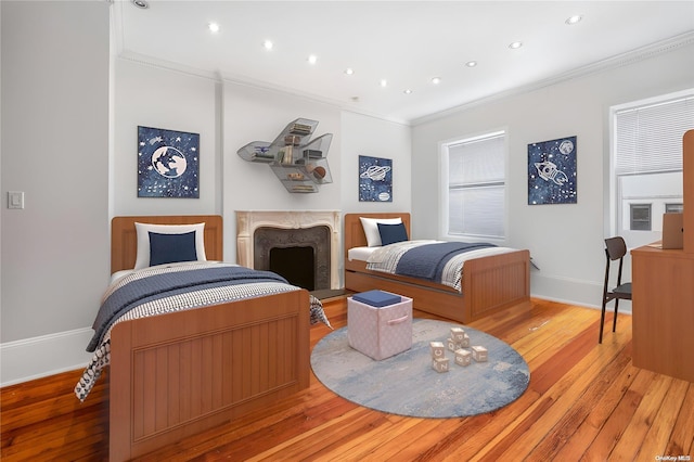 bedroom featuring crown molding and light wood-type flooring