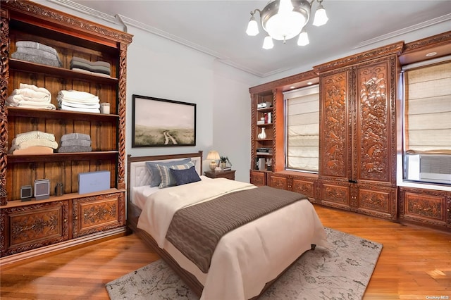 bedroom featuring multiple windows, crown molding, and light hardwood / wood-style flooring