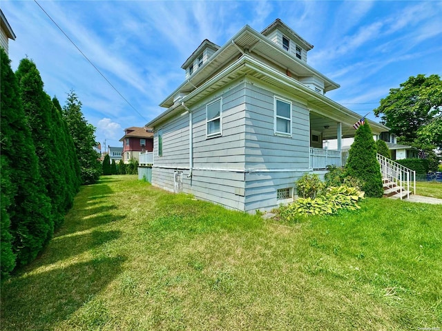 view of side of home featuring a yard