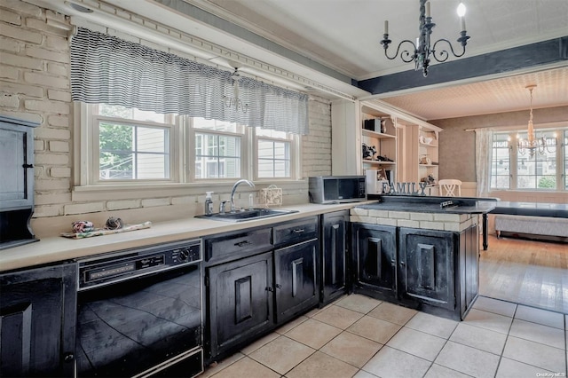 kitchen featuring kitchen peninsula, sink, light hardwood / wood-style flooring, dishwasher, and hanging light fixtures