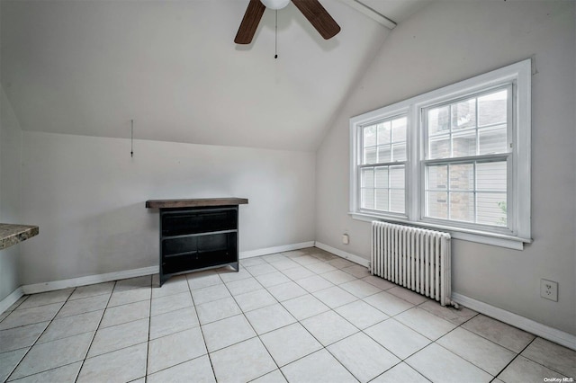 additional living space featuring radiator heating unit, light tile patterned floors, ceiling fan, and lofted ceiling