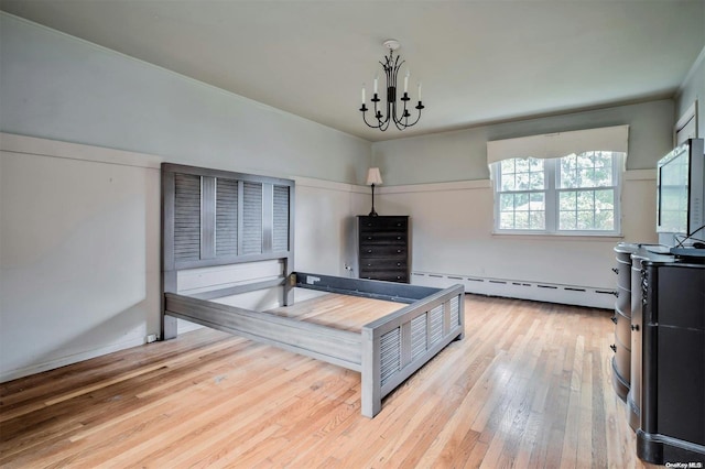 bedroom with light wood-type flooring, a baseboard heating unit, and a notable chandelier