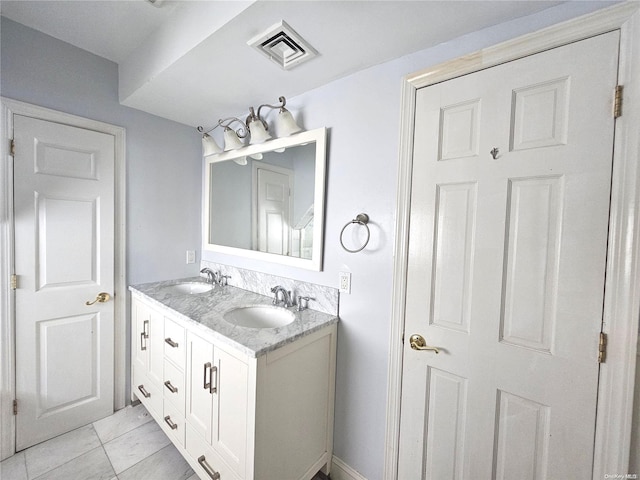 bathroom with tile patterned flooring and vanity