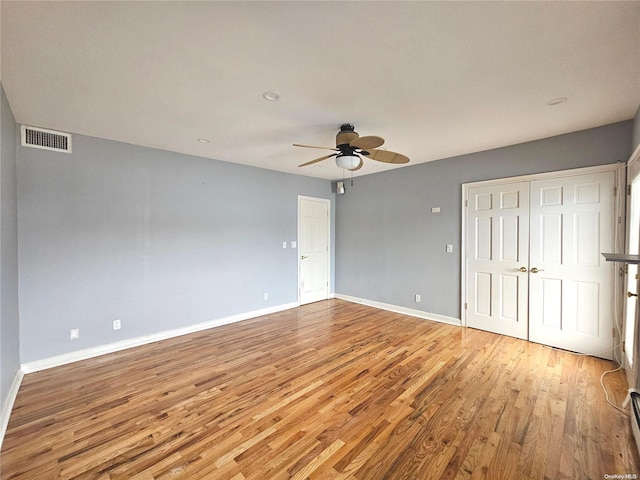 unfurnished bedroom with ceiling fan and wood-type flooring