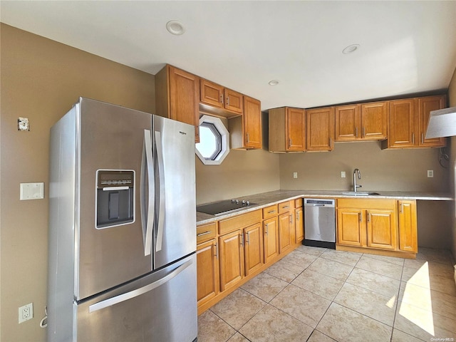 kitchen featuring light tile patterned flooring, sink, and stainless steel appliances