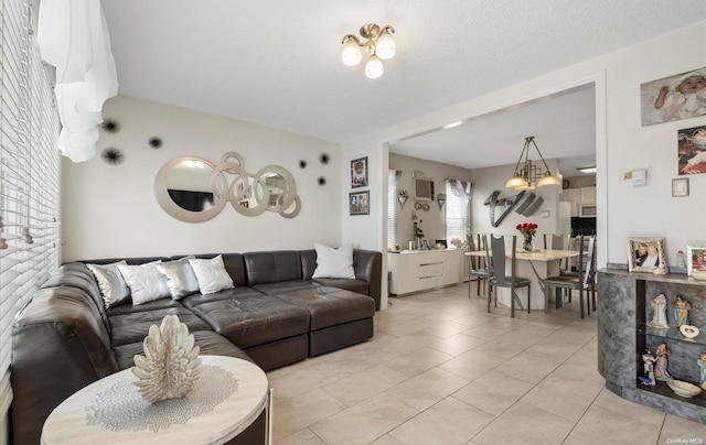 living room featuring light tile patterned floors and a textured ceiling