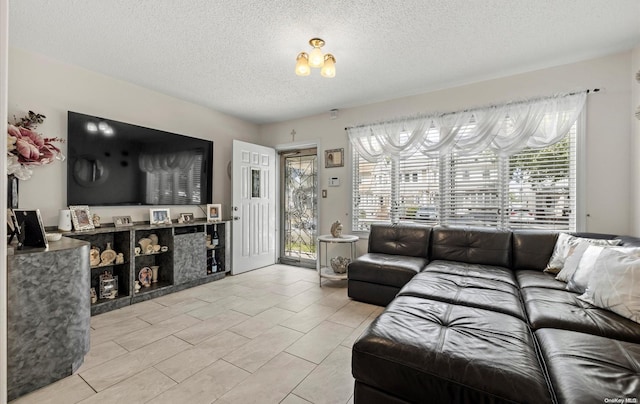 living room featuring a wealth of natural light, light tile patterned floors, and a textured ceiling