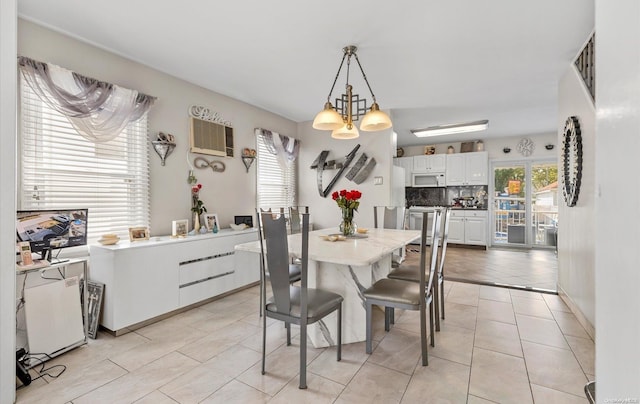 dining room with light tile patterned floors and a chandelier