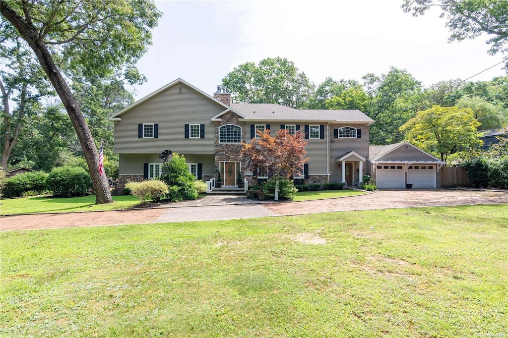 view of front of home with a garage and a front yard