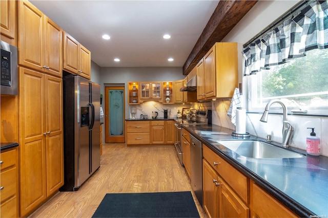 kitchen featuring sink, stainless steel appliances, range hood, backsplash, and light hardwood / wood-style floors