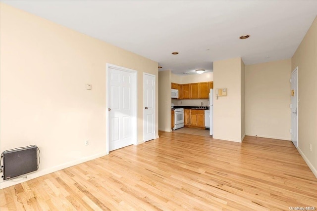 unfurnished living room with light wood-type flooring