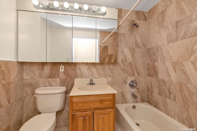 full bathroom with tiled shower / bath combo, toilet, tile walls, and vanity