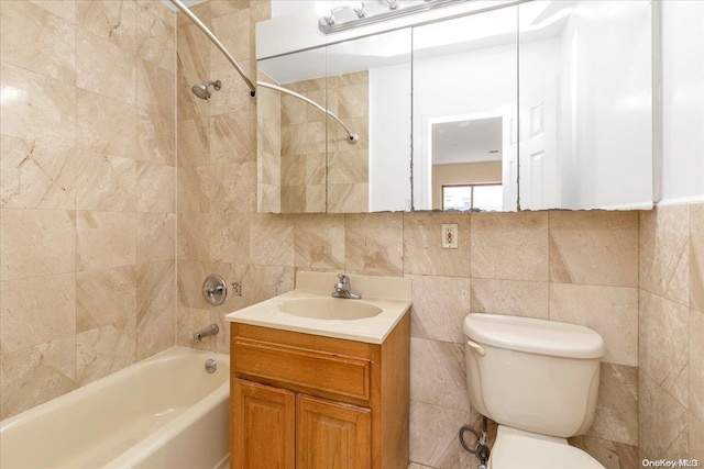 full bathroom with tiled shower / bath combo, tile walls, and vanity