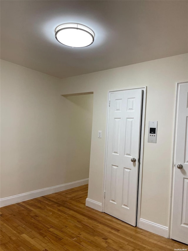 spare room with wood-type flooring