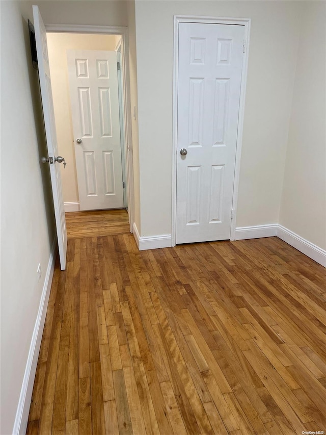 unfurnished bedroom featuring a closet and light hardwood / wood-style flooring