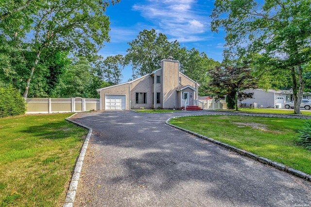 view of front of home featuring a garage and a front yard