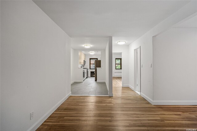 hall with hardwood / wood-style floors