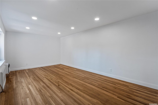 unfurnished room with hardwood / wood-style flooring