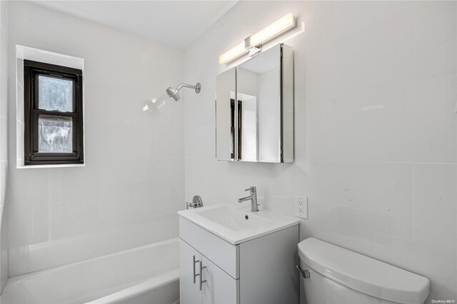 full bathroom featuring washtub / shower combination, vanity, and toilet