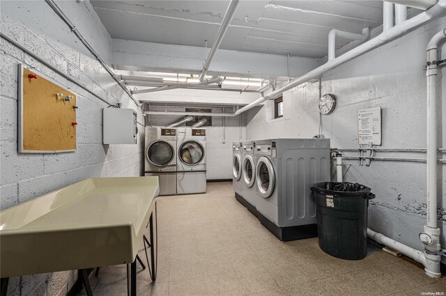 clothes washing area with washing machine and clothes dryer