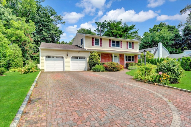 view of front of home featuring a front yard and a garage