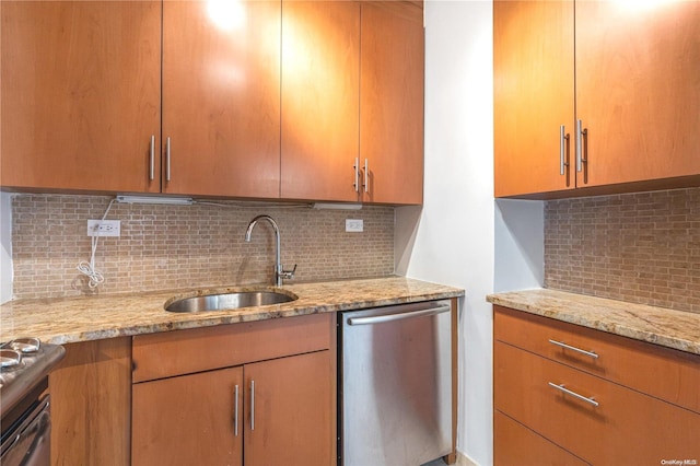 kitchen featuring decorative backsplash, stainless steel dishwasher, light stone countertops, and sink