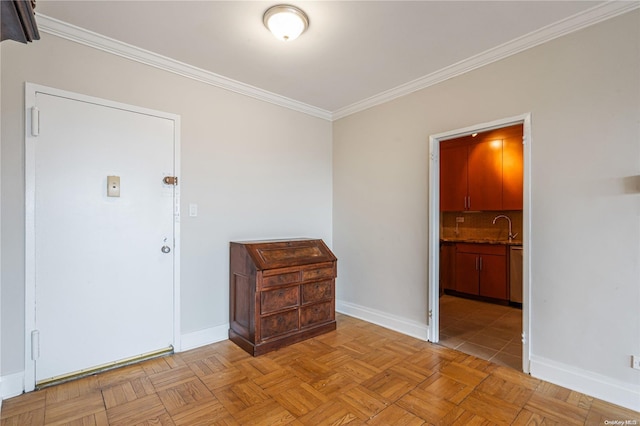 interior space with light parquet flooring, ornamental molding, and sink