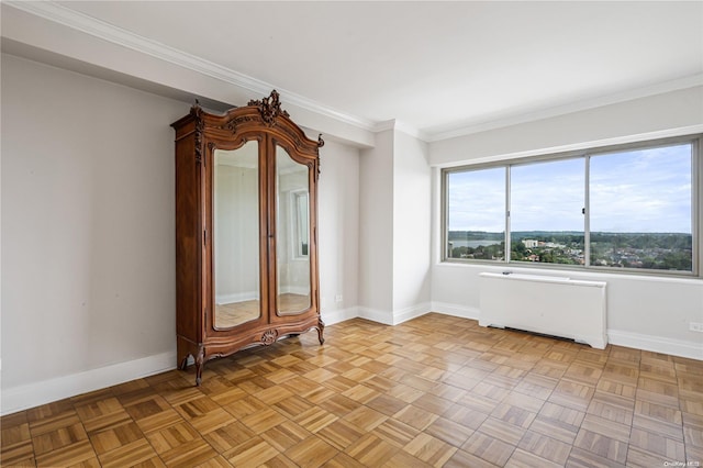 spare room featuring radiator heating unit, light parquet flooring, and ornamental molding