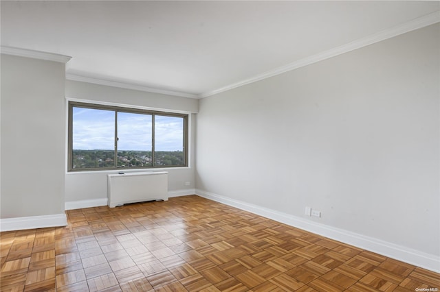 empty room with radiator heating unit, light parquet floors, and crown molding