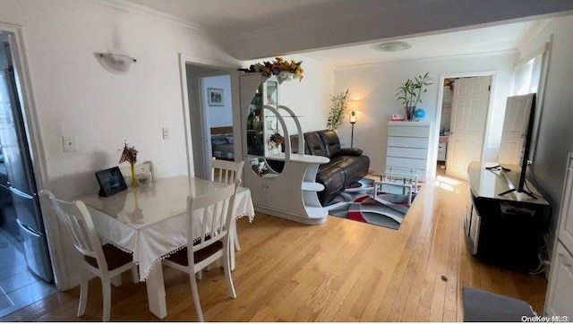 dining room featuring hardwood / wood-style floors and ornamental molding