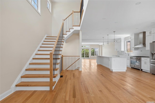 stairs featuring hardwood / wood-style floors