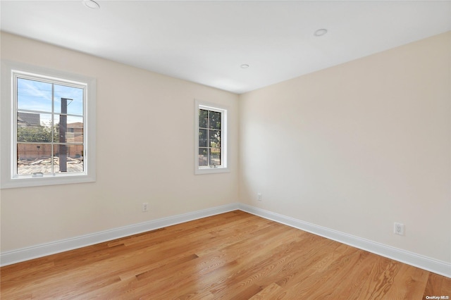 unfurnished room featuring a healthy amount of sunlight and light hardwood / wood-style floors