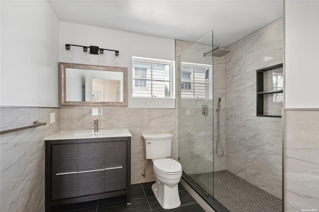 bathroom with tile patterned floors, toilet, tile walls, and tiled shower