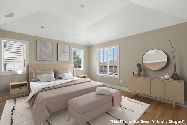 bedroom with vaulted ceiling and dark wood-type flooring