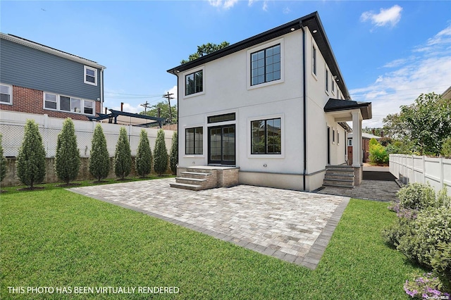 rear view of property with a lawn and a patio area