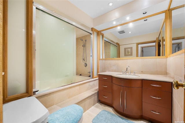 bathroom with vanity, tile patterned floors, and enclosed tub / shower combo