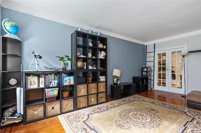 interior space featuring parquet flooring, french doors, crown molding, and brick wall