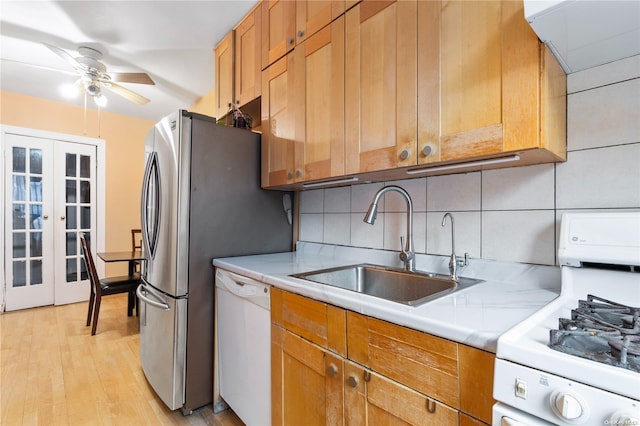 kitchen with ceiling fan, french doors, sink, light hardwood / wood-style flooring, and white appliances