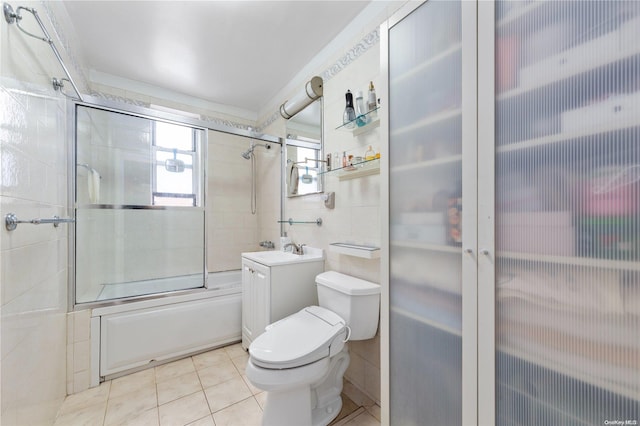 full bathroom featuring vanity, tile walls, enclosed tub / shower combo, tile patterned flooring, and toilet