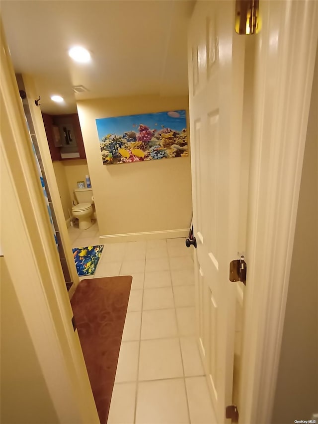 bathroom with toilet and tile patterned floors