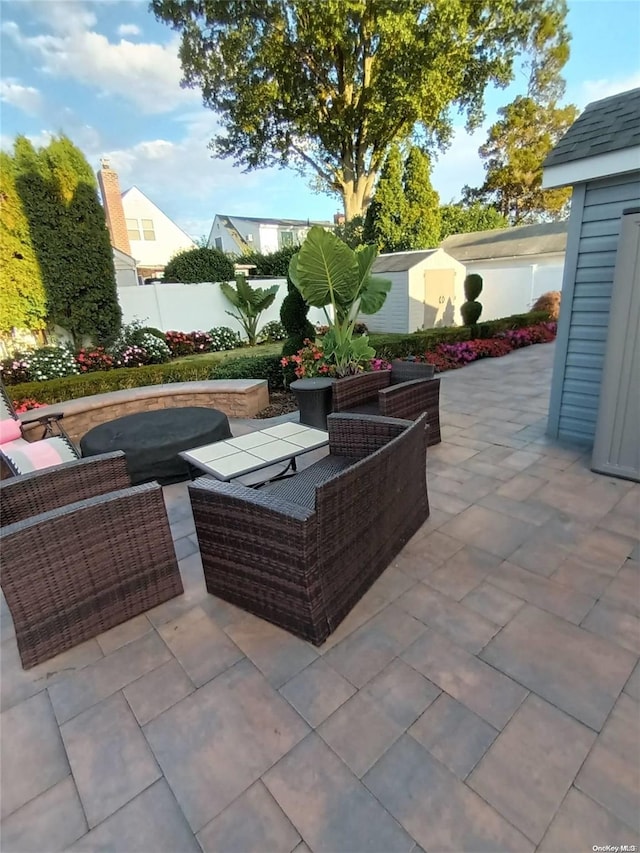 view of patio / terrace featuring an outdoor living space and a shed