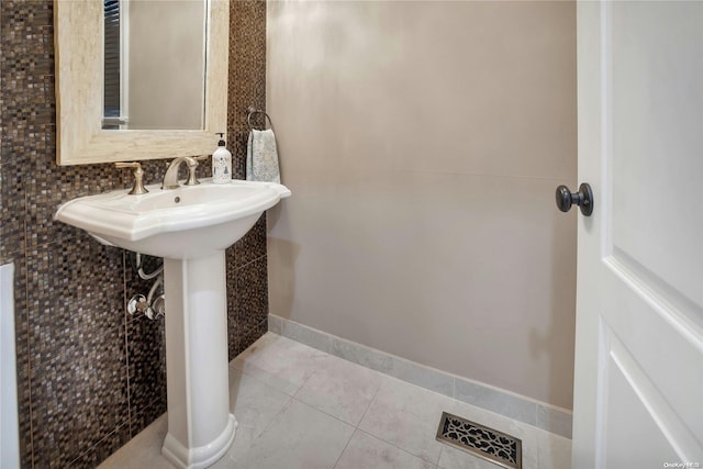 bathroom featuring tile patterned floors and decorative backsplash