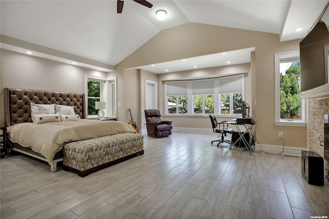 bedroom with vaulted ceiling, light hardwood / wood-style floors, and multiple windows