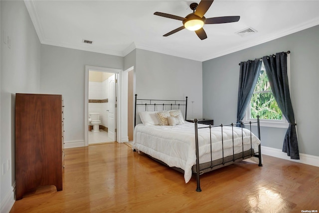 bedroom with connected bathroom, light hardwood / wood-style flooring, ceiling fan, and ornamental molding